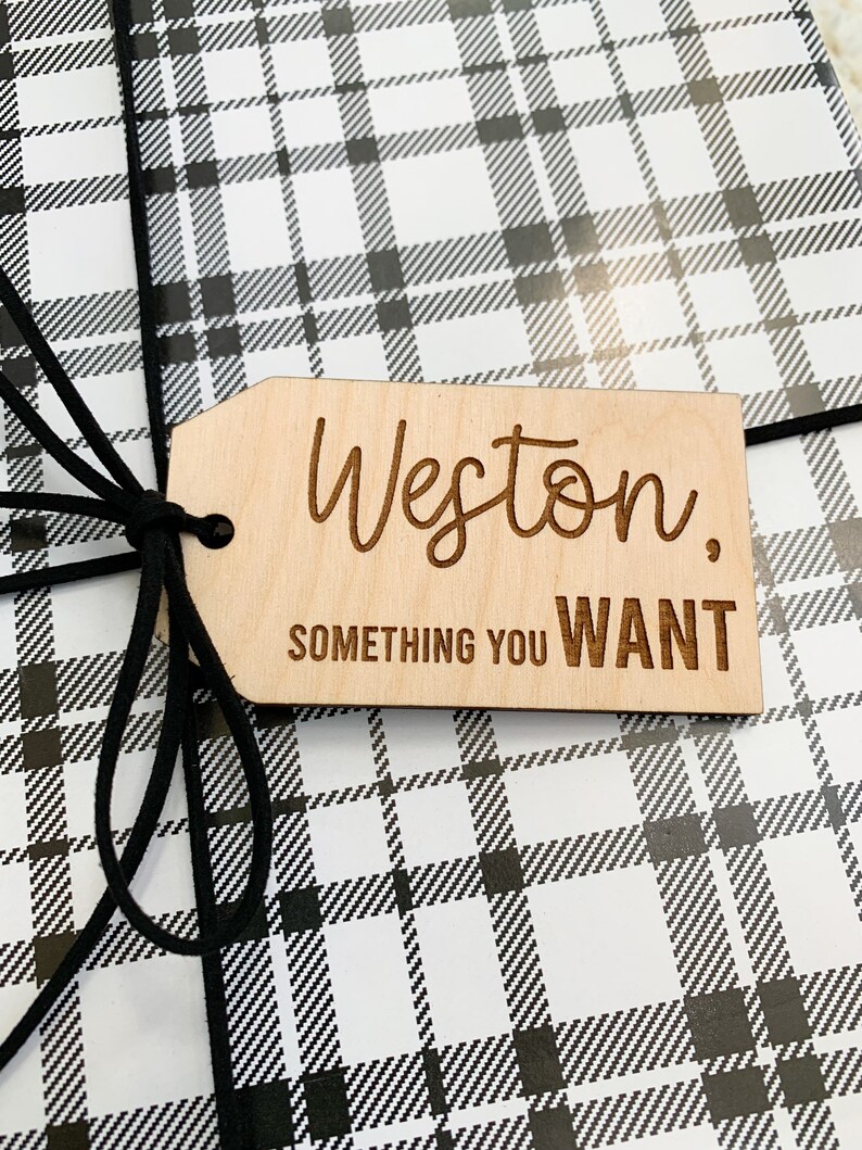May include: A wooden gift tag with the name Weston and the text "Something you WANT" in black lettering.