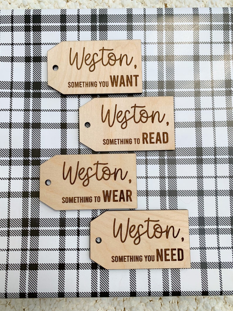 May include: Four wooden gift tags with the name Weston and a category for the gift. The categories are something you want, something to read, something to wear, and something you need.