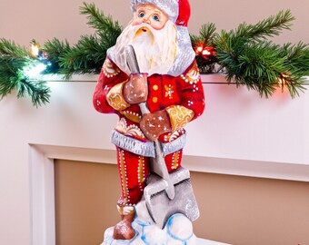 Santa Figurine 7.1″, Hand‑Carved Wood, Snow Shovel, Gold Accents
