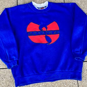 Op de afbeelding: Een witte keramische mok met een zwart handvat en de tekst "But First, Coffee" in een vetgedrukte, zwarte letter. De mok staat tegen een vage achtergrond, wat een gezellige setting suggereert.