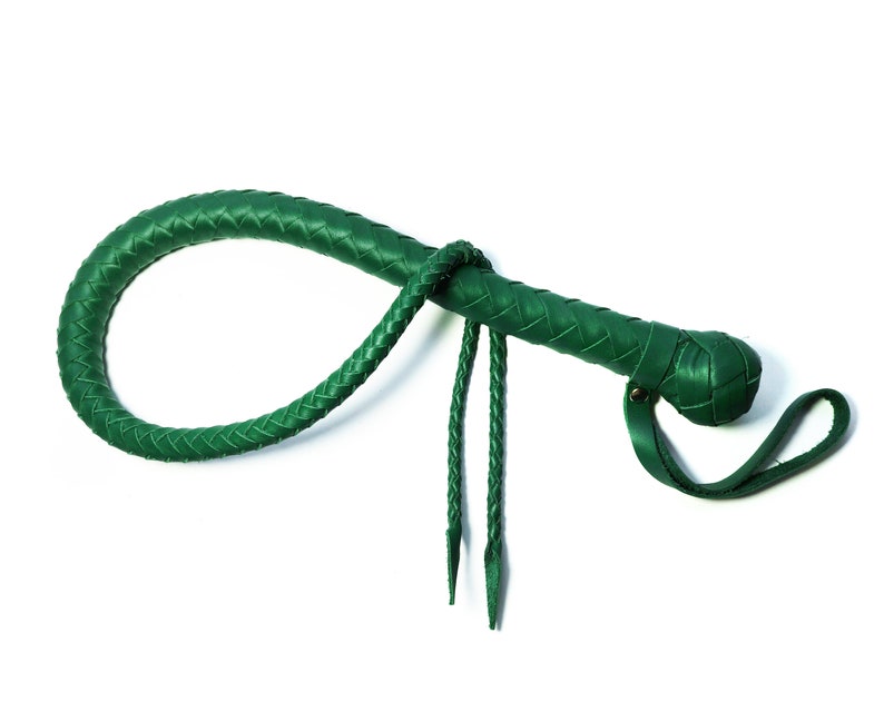 May include: A green leather bullwhip with a braided handle and a loop at the end.