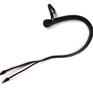 May include: A black leather bullwhip with a braided handle and a loop at the end. The whip has two tails that are braided and end in points.