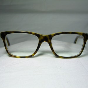 May include: Tortoise shell eyeglasses with a rectangular frame and clear lenses.