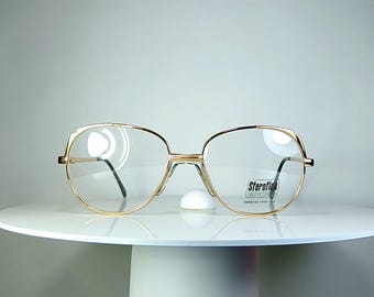 Lunettes de vue LUXOTTICA, monture papillon ovale festonnée plaquée or New Old Stock