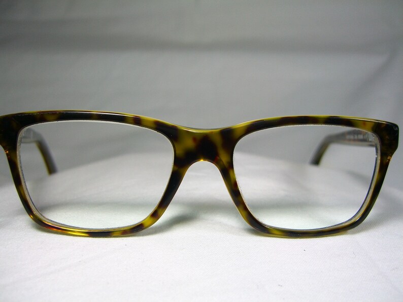 May include: Tortoise shell eyeglasses with a clear lens.