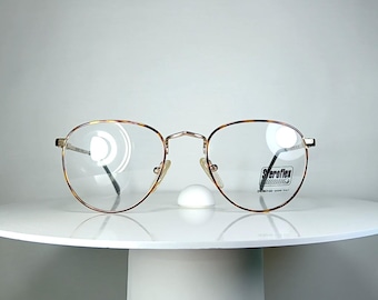 Gafas LUXOTTICA ovaladas con montura chapada en oro. Nuevas, sin usar.