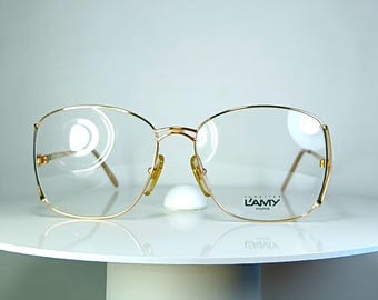 Gafas de lujo L'Amy con montura ovalada festoneada chapada en oro.