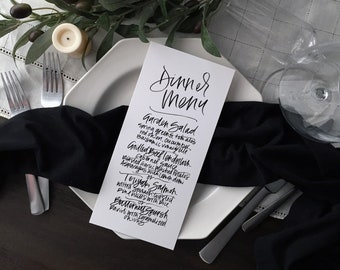 Hand lettered white and black dinner party wedding menu