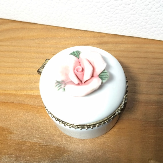 White porcelain thinket with a rose on the top. - image 1