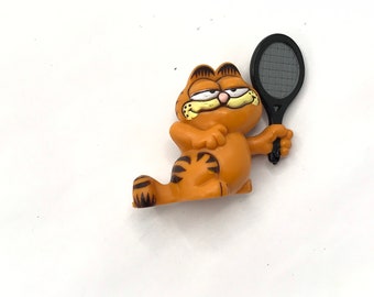 Gorgeous collectible and vintage Garfield is playing tennis.