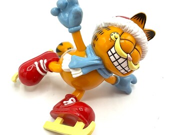 Gorgeous collectible and vintage ornament as Garfield is ice skating , trim-a-tree ornament . With the original box.
