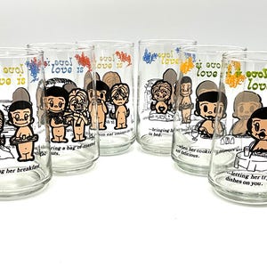 May include: Set of six clear glass tumblers with colorful cartoon couples and the text "Love is..." with different phrases about love.