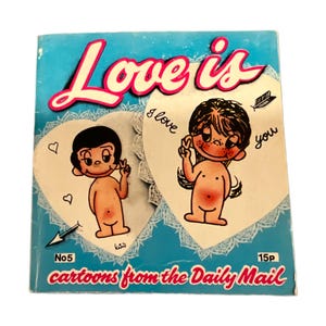 May include: A vintage "Love is" cartoon booklet with a light blue cover. The title is in pink script. Two heart-shaped illustrations show cartoon figures. Text includes "I love you" and "cartoons from the Daily Mail."