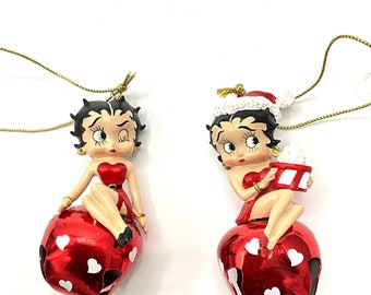 Gorgeous collectible and vintage Betty Boop small  with red dress, sitting at the bell or with a present.