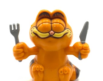 Vintage Garfield holding a knife and fork , figurine, cat, orange.