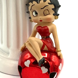 Vintage Betty Boop small  with red dress, sitting at the bell, ornament.