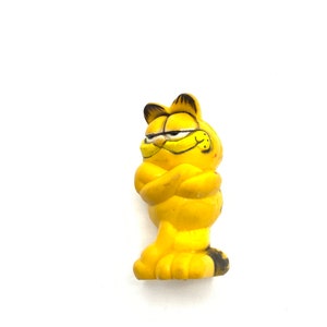 Gorgeous collectible and Vintage Garfield figurine with arms cross, eraser.