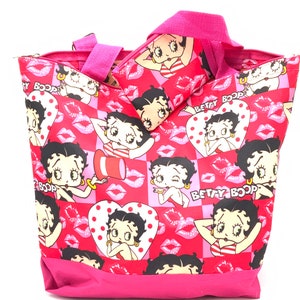 Gorgeous collectible Betty Boop pink material purse with small wallet.
