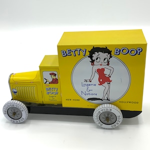 Gorgeous collectible and vintage Betty Boop tin car, yellow, “lingerie & notions”.