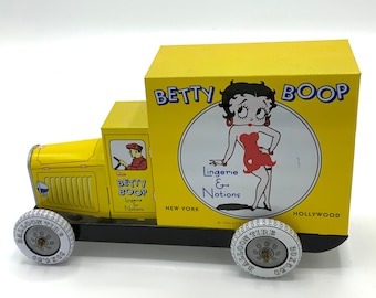 Gorgeous collectible and vintage Betty Boop tin car, yellow, “lingerie & notions”.