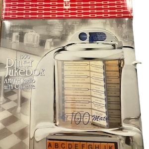 May include: A chrome-finished 1950s diner jukebox with AM/FM radio and cassette player. The jukebox features a selection of songs, a coin slot, and a numeric keypad. The text "1950 Diner Jukebox" is visible.