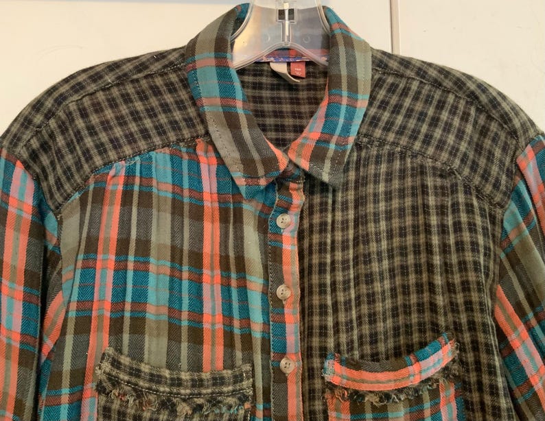 May include: A long-sleeved plaid shirt with a patchwork design. The shirt is made of a soft, comfortable fabric and features a button-up closure. The shirt is available in a variety of colors, including green, blue, and orange.