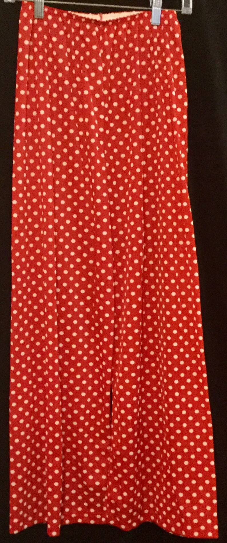 May include: Red wide-leg pants with a white polka dot pattern.
