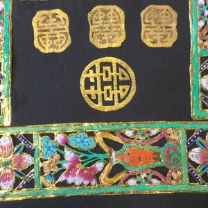 May include: A set of four gold-colored Chinese wedding decorations with intricate designs. The decorations are made of paper and are cut out in the shape of flowers, vases, and the Chinese character for "double happiness".