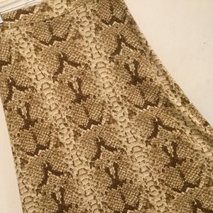 May include: A brown and beige skirt with a snakeskin pattern.