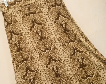 May include: A brown and beige skirt with a snakeskin pattern.