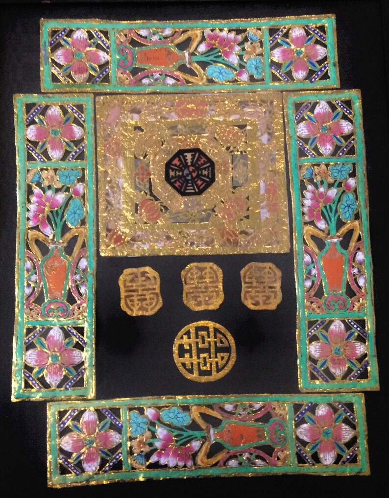 May include: A black square frame with gold and green accents. The frame is decorated with floral patterns and Chinese characters. The center of the frame features a gold octagon with a black center.