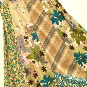 May include: A long, multi-colored skirt with a patchwork design. The skirt is made of different fabrics with floral patterns in shades of green, blue, and brown.