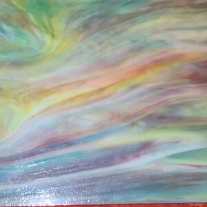 May include: A sheet of iridescent glass with a swirling pattern of blue, green, yellow, and purple hues.