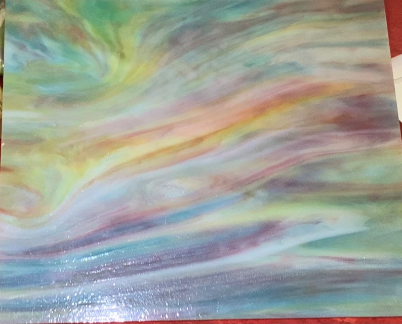 May include: A sheet of iridescent glass with a swirling pattern of blue, green, yellow, and purple hues.