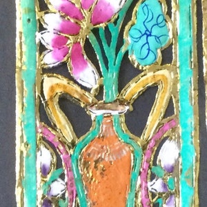 May include: A decorative panel with a gold, green, and blue frame. The panel features a vase with flowers in pink, white, and blue. The flowers are stylized and have a delicate, intricate design.