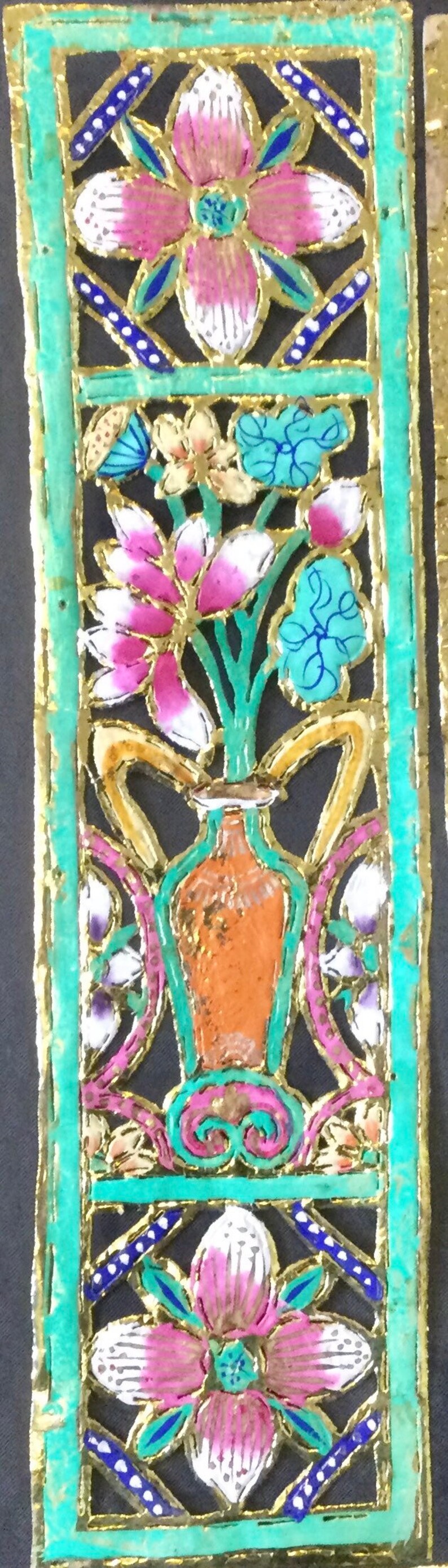 May include: A decorative panel with a gold, green, and blue frame. The panel features a vase with flowers in pink, white, and blue. The flowers are stylized and have a delicate, intricate design.
