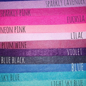 May include: A swatch card showing ten different shades of felt fabric. The colors are: Sparkly Indigo, Sparkly Lavender, Sparkly Pink, Fuchsia, Neon Pink, Lilac, Plum Wine, Violet, Blue Black, Blue, Sky Blue, Light Sky Blue, and Sea Foam.