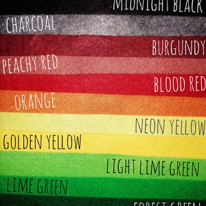 May include: A color chart with 12 different colors of felt fabric. The colors are: snow white, midnight black, charcoal, burgundy, peachy red, blood red, orange, neon yellow, golden yellow, light lime green, lime green, forest green, and baby blue.
