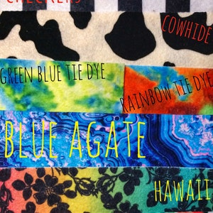 May include: A collection of fabric swatches with different patterns and colors, including camouflage, checkers, cowhide, tie dye, blue agate, floral, and watercolor.