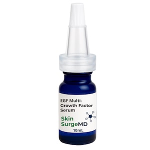 May include: A small, dark blue glass bottle of Skin SurgeMD EGF Multi-Growth Factor Serum. The bottle has a white label with black and green text and a clear plastic applicator top. The bottle contains 10mL of serum.