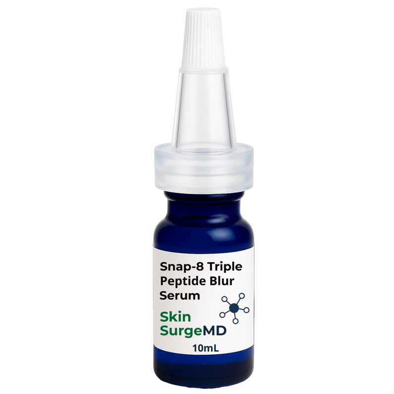 May include: A small blue glass bottle of Snap-8 Triple Peptide Blur Serum by Skin SurgeMD. The bottle features a white label with black and green text, a clear plastic applicator tip, and a volume capacity of 10mL printed on the front label.