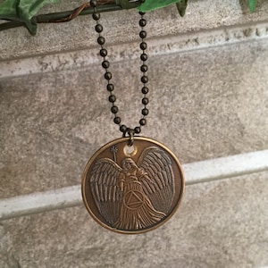 Guardian Angel AA token medallion pendant on bronze chain.