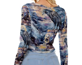 May include: A long-sleeved, sheer, blue and purple top with a watercolor-style print of ravens and skulls. The top has a scoop neck and a fitted silhouette.