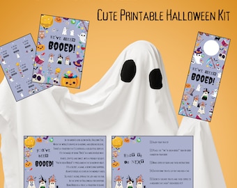 May include: A printable Halloween kit featuring the text "YOU'VE BEEN BOOED!" and "CUTE PRINTABLE HALLOWEEN KIT". The set includes cards, door hangers, and instruction sheets decorated with colorful ghosts, pumpkins, and bats on a light purple background.