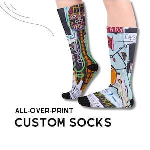 May include: A pair of custom socks with an all-over print featuring a colourful abstract design with black outlines and the text "ARY CAS".