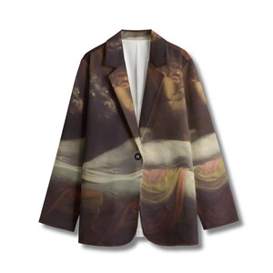 May include: A long-sleeve blazer featuring a dark, classical oil painting print of figures and draped fabric. The garment has a notched lapel, a single black button closure at the center, two front pockets, and a solid white interior lining.
