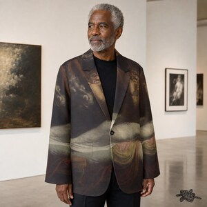 May include: A single-button blazer featuring a dark, painterly print with muted tones of brown, cream, and deep red. The jacket has a notched lapel, long sleeves, and a straight hem, worn over a solid black shirt. The fabric displays a classical art motif.