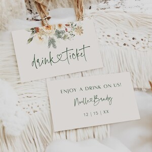 May include: Two white drink tickets with green calligraphy. The top ticket has a floral design and the text "drink & ticket". The bottom ticket has the text "ENJOY A DRINK ON US! Noelle & Brady 12 | 15 | XX".