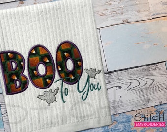 May include: White Halloween-themed towel with the embroidered phrase "BOO To You." The letters "BOO" are filled with a pattern of candy corn and outlined in purple. Two small gray bat designs are embroidered near the words.
