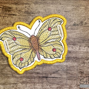 May include: Yellow butterfly embroidery design with red accents. The butterfly is outlined in yellow thread and has a white background.